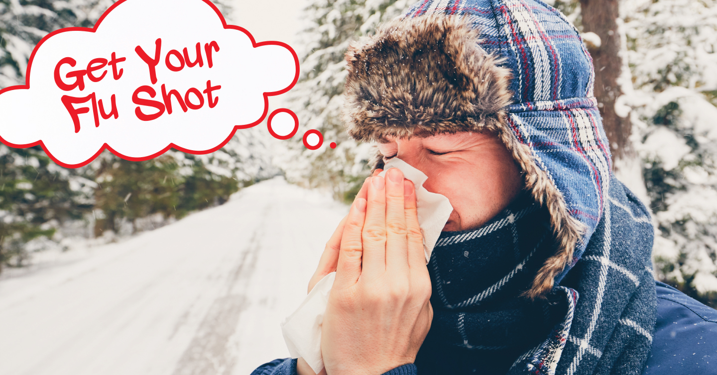 a person blowing their nose in winter thinking about how everyone should get their flu shot