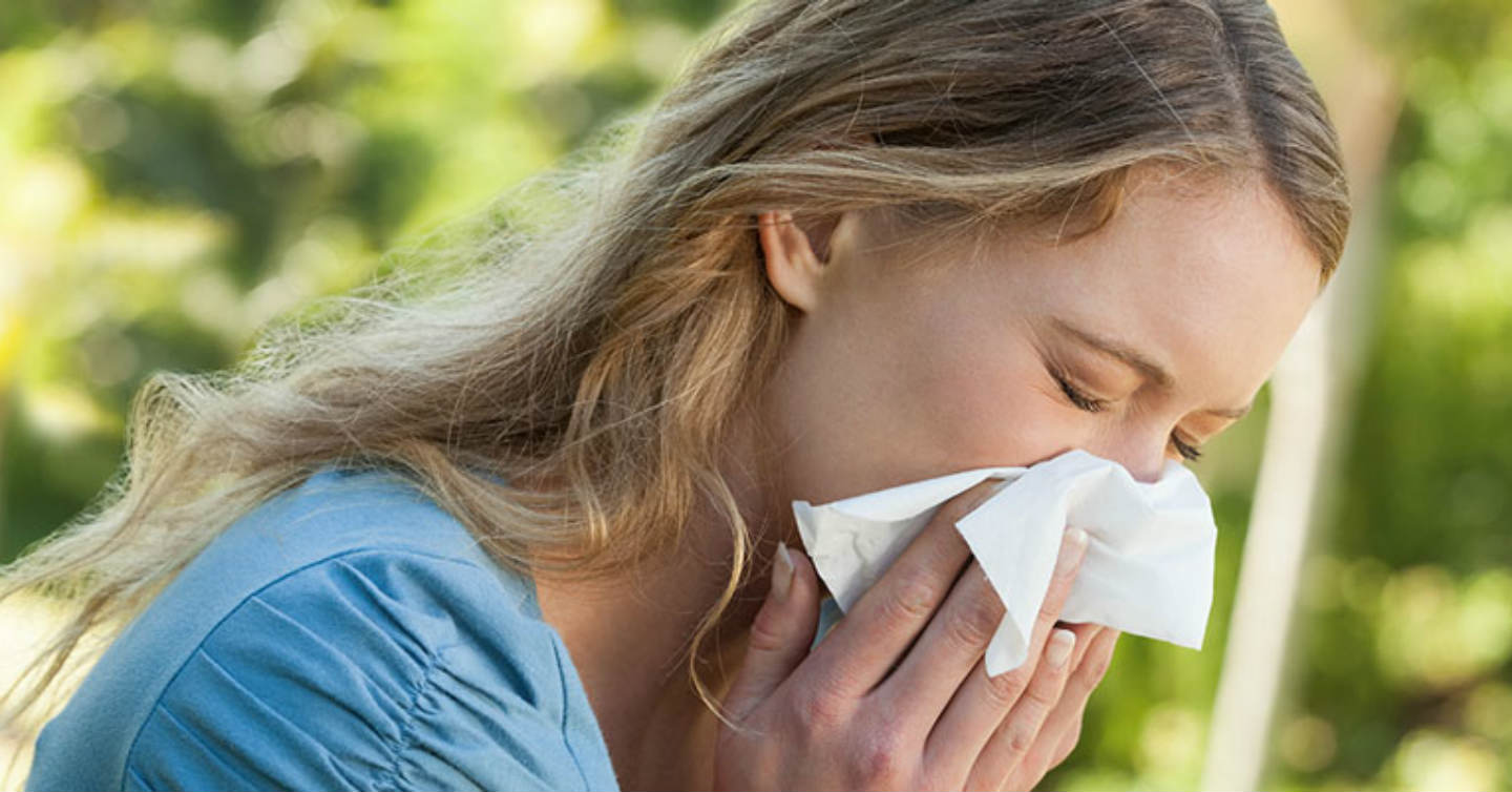 woman sneezing due to spring allergies in wisconsin