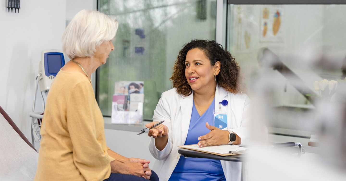 a doctor talking to a patient about whether to stop mammograms