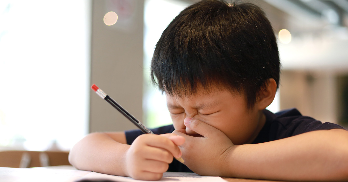 a child sneezing from allergies at school