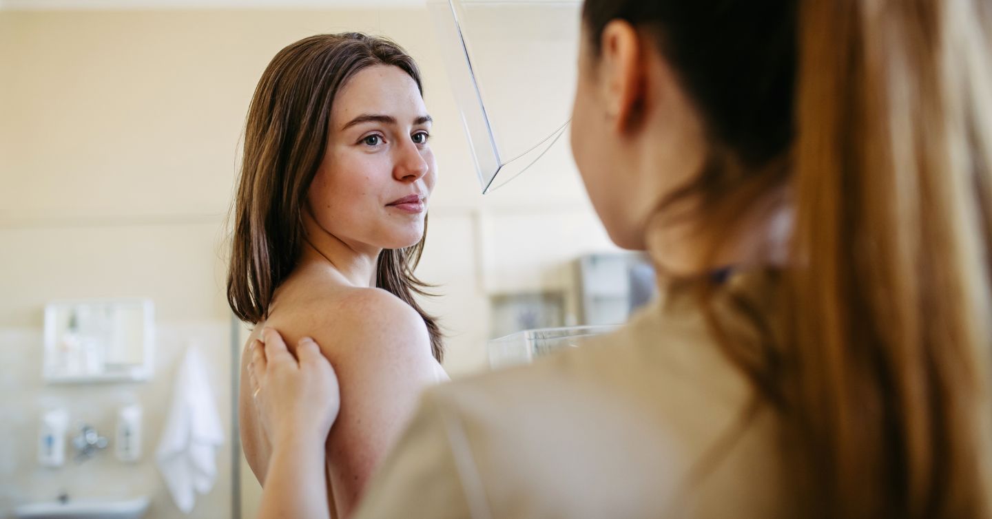 a young woman under 40 getting a mammogram